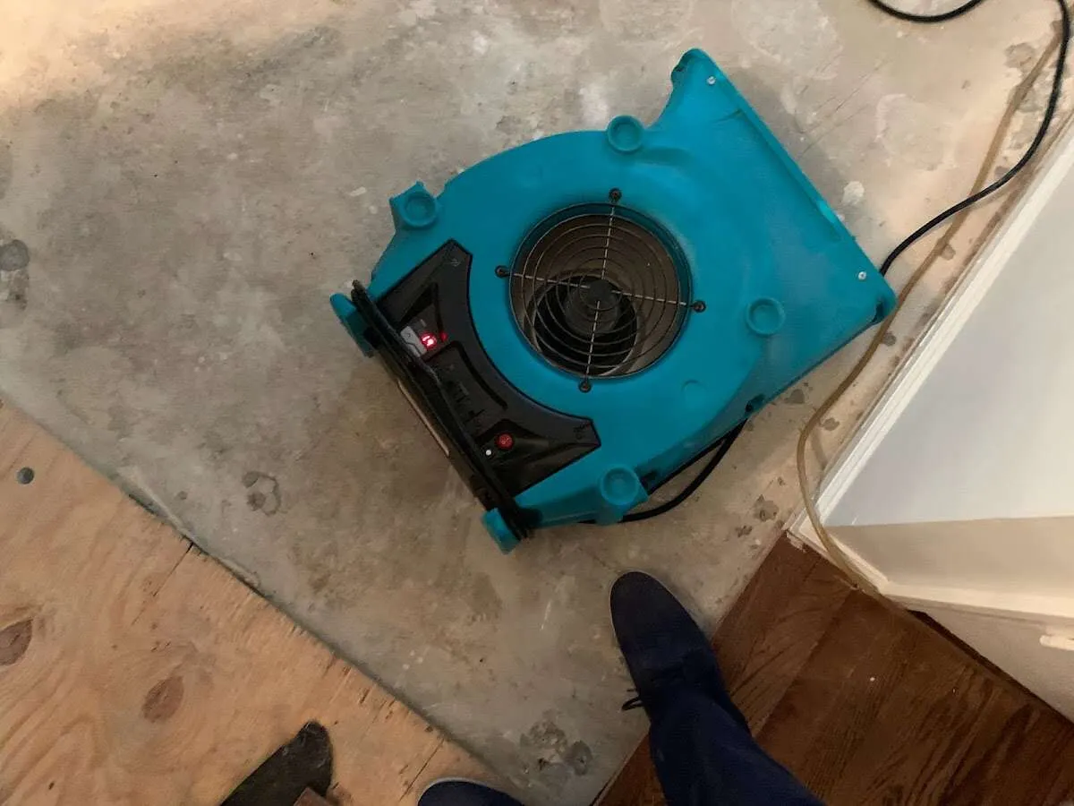 Air mover drying subfloor during Leak Detection & Repair in Suffern